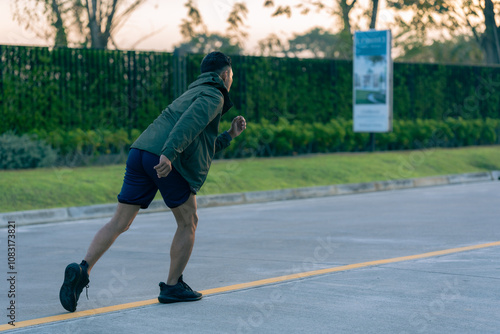 Man jogging in the park Man running on a sunny day Smile and have fun with outdoor activities, motivation, fitness, exercise. and male runners in exercise photo