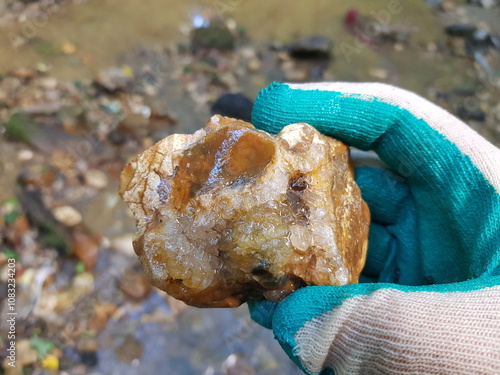 Vászonkép Quartz druse on a flint fragment in hand, rockhounding, field photo