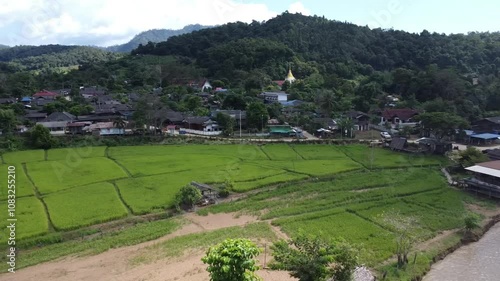 Villages, rice fields and forests surrounded by mountains in northern Thailand