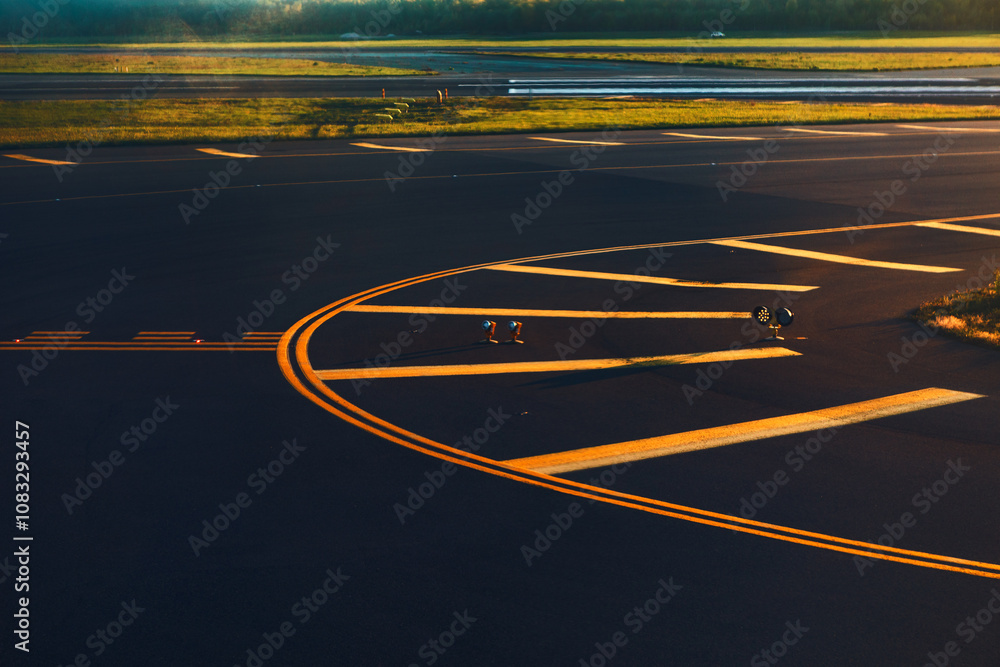Airport runway with various yellow lines and markings on the asphalt to guide aircraft. Design and organization for airport runway operations