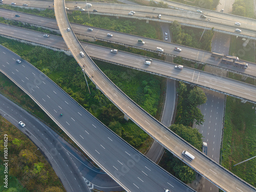 Aerial view car transport on city junctiion road morning light