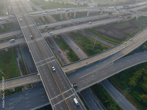 Aerial view car transport on city junctiion road morning light