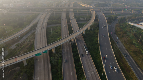 Aerial view car transport on city junctiion road morning light