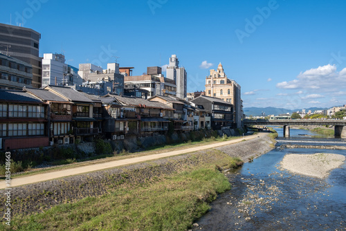 Obraz na płótnie Kamo River, Kyoto, Japan The riverbanks are popular walking spots for resident and tourist. It's walkways running alongside the river, and some stepping stones that cross the river w salonie