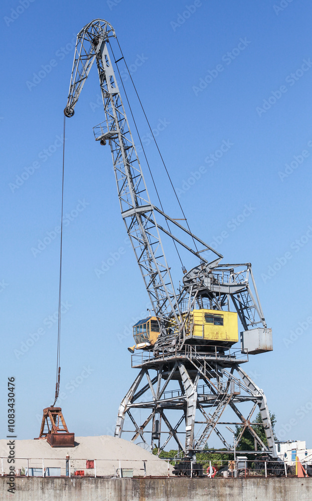 Fototapeta premium Portal crane works on the river coast