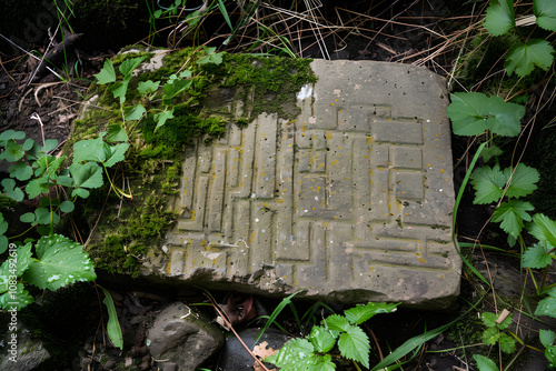 Ancient Celtic Ogham Inscriptions on a Time-worn Stone Slab - Glimpse into the Mysterious Historical Past photo