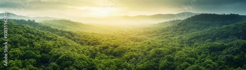 Expansive view of lush green mountains under soft sunlight.