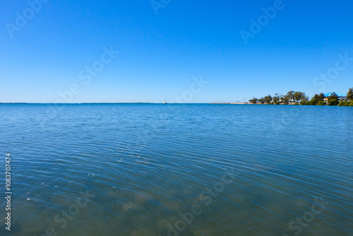 Walking along the seaside at Wynnum jetty and Manly, a beautiful sunny clear and blue sky day  photo