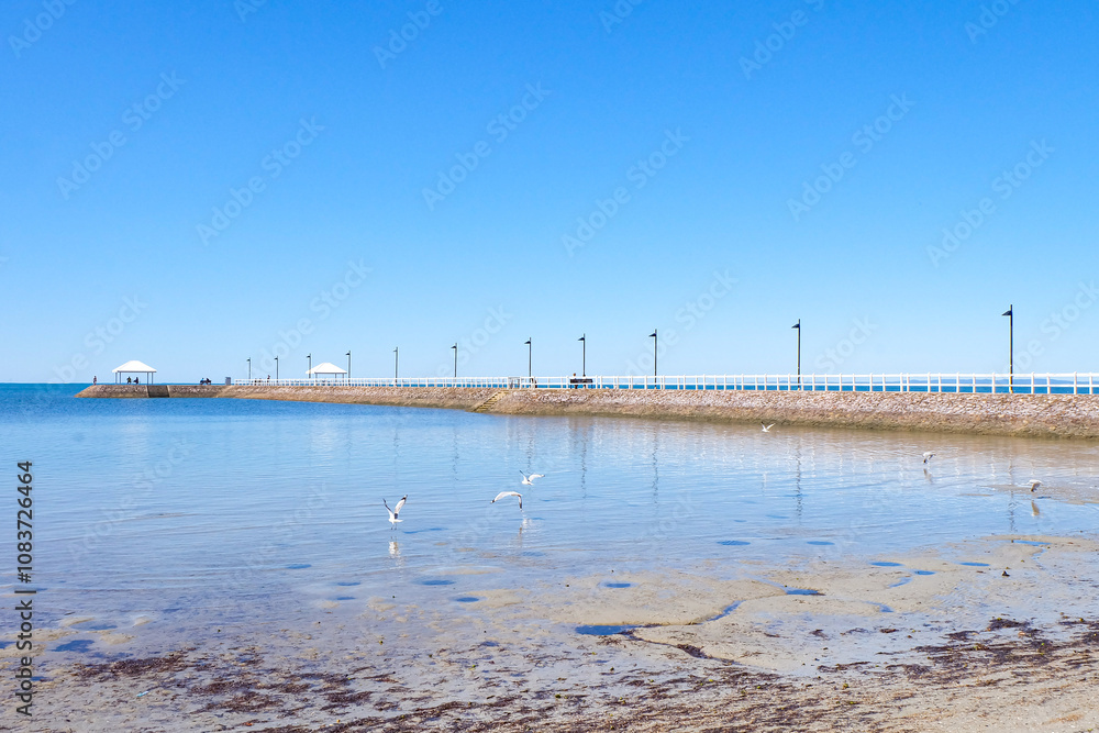 Fototapeta premium Walking along the seaside at Wynnum jetty and Manly, a beautiful sunny clear and blue sky day 