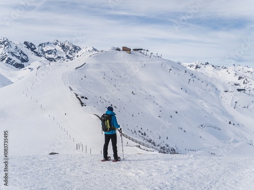 Solo Snowshoer Hiking in Winter Mountain Landscape photo