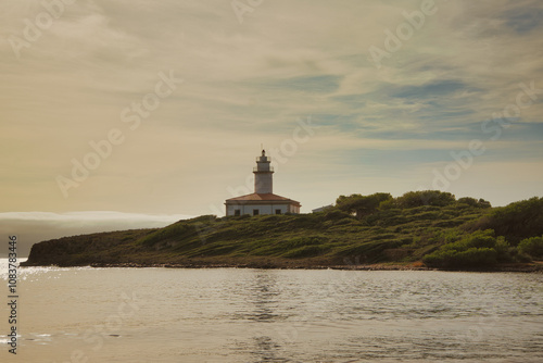 Alcanada lighthouse at dawn, the only lighthouse on an islet in Mallorca photo