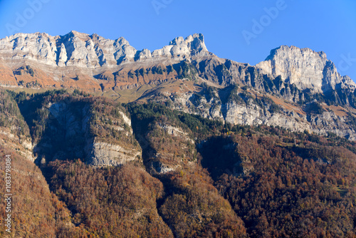 Beautiful mountain panorama with mountain peaks named Churfirsten on a sunny summer morning in bright sunlight with blue sky background. Photo taken November 15th, 2024, Walensee, Switzerland. photo