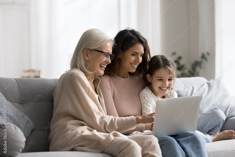 © fizkes - Multigenerational family spend weekend together resting on sofa with laptop, laughing while watching on-line movie, enjoy video call chat, choose and buy goods through marketplace websites. Technology © fizkes - Multigenerational family spend weekend together resting on sofa with laptop, laughing while watching on-line movie, enjoy video call chat, choose and buy goods through marketplace websites. Technology