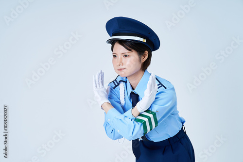 制止するポーズをする女性警備員 photo