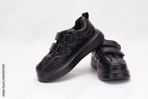 A pair of sleek sneakers featuring velcro straps, providing both style and comfort, placed on a white background. Ideal shoes for casual and everyday use, waterproof