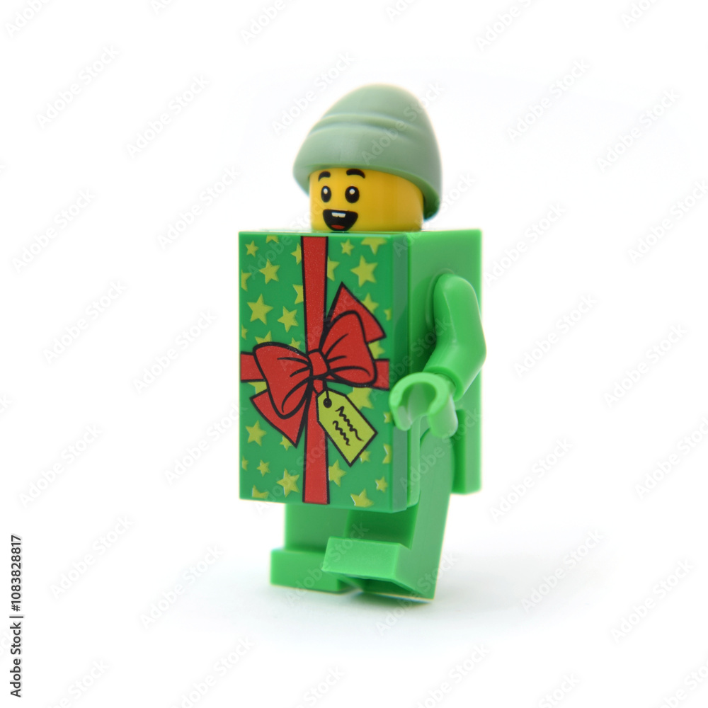 Fototapeta premium Lego minifigure in green celebrate present box costume. Editorial illustrative image of holiday christmas in popular children toy.