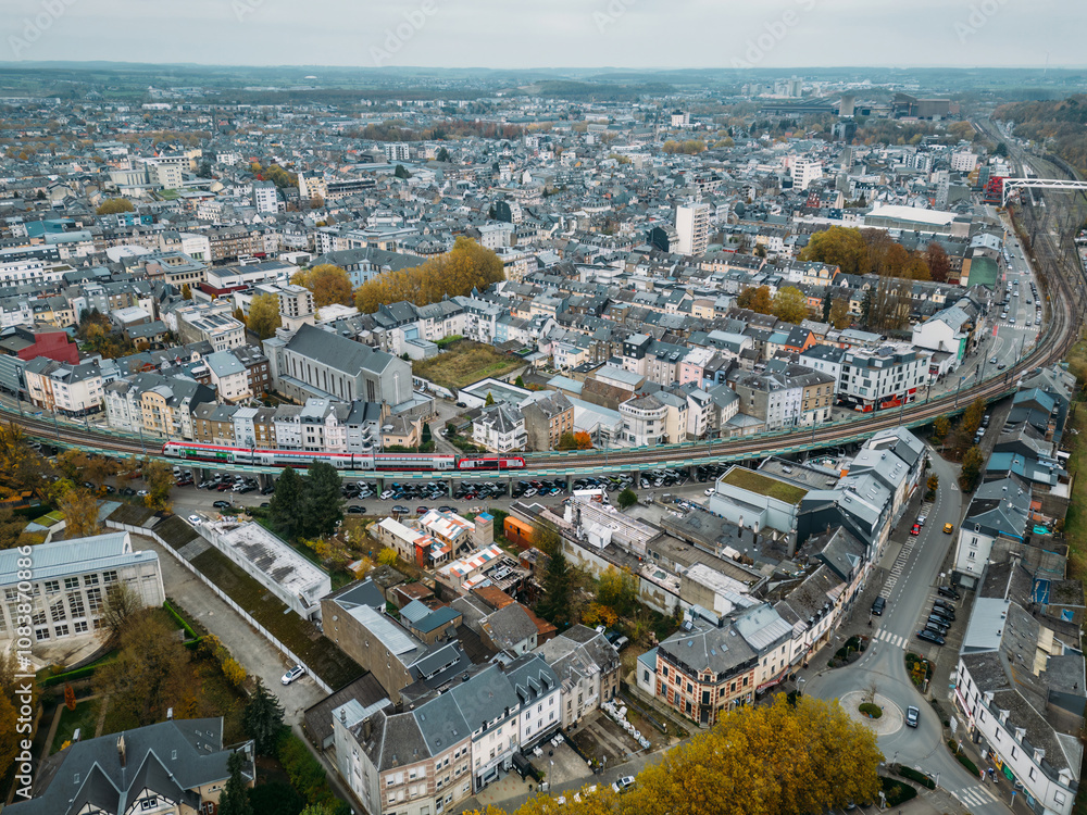 Fototapeta premium Aerial drone view of Esch-sur-Alzette city centre, Luxembourg showcasing urban landscape and surrounding nature in fall
