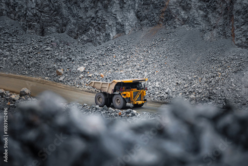 Heavy Duty Mining Truck Navigating Rocky Terrain in Quarry Site photo