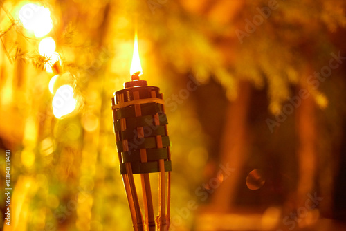 Canvastavla bamboo torches at night with yellow flames and highlights