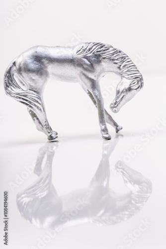 silver horse plastic toy magical standing in studio with reflection