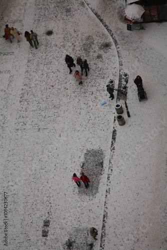 Photography people walking on the street under the snow in Prague, airial view