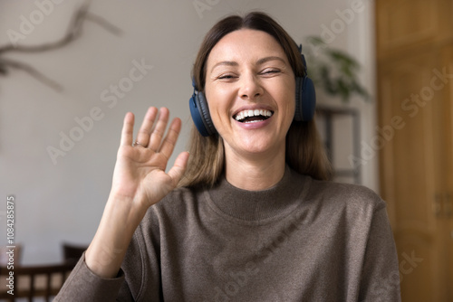 Photos Head shot portrait happy woman wear headphones start videocall talk using application, web cam view face