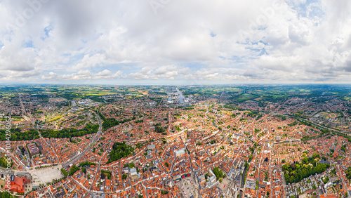 Bruges, Belgium. City center and surroundings. Residential and industrial areas. Panorama of the city. Summer day, cloudy weather. Aerial view