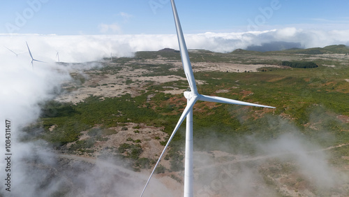 Wind Turbine Among Clouds in Scenic Landscape