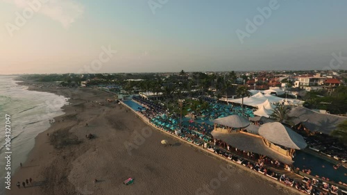 fpv drone aerial view of the beach club at sunset in bali