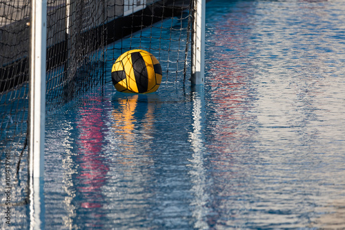 Water polo ball floating near net