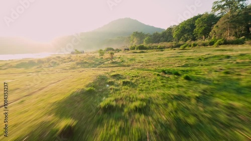 fpv drone aerial view morning  landscape with grass and fog in bali 