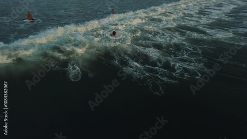 fpv drone view of surfing at sunset in bali