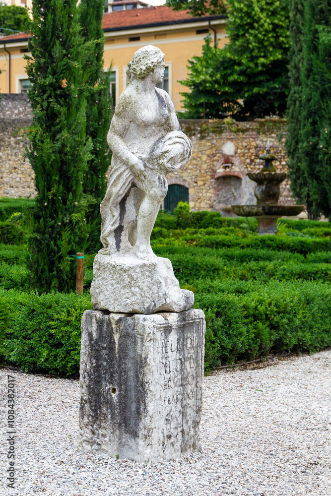 a marble stature in the beautiful and unique city garden called Giardino Giusti in Verona, Italy. a marble stature in the beautiful and unique city garden called Giardino Giusti in Verona, Italy.