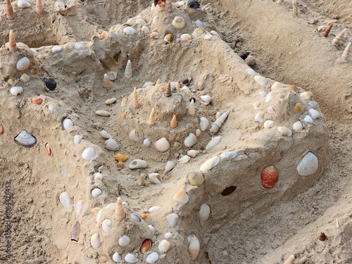 Building sandcastles with seashells beach art activity coastal environment ground level creative fun photo