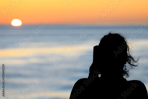 People enjoying the sunset while sailing with a ferry over the tidal mudflats of the Waddensea, The Netherlands photo