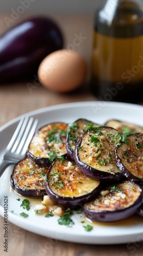 Grilled eggplant with garlic and olive oil styled on a white plate with fresh herbs, a fork, and an open bottle of olive oil against a wooden backdrop