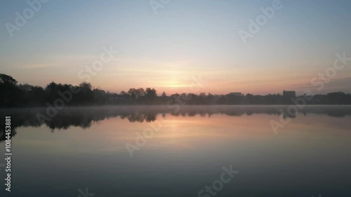 Foggy morning aerial video of a lake and city of Lubeck