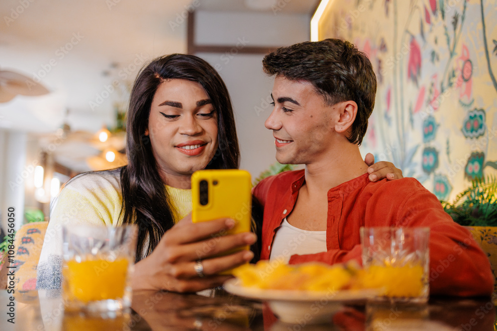 Latin couple enjoying breakfast and browsing smartphone in restaurant: