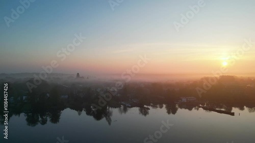 Foggy morning aerial video of a lake and city of Lubeck
