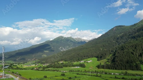 Aerial video of a valley in Austrian Alps, buildings and nature