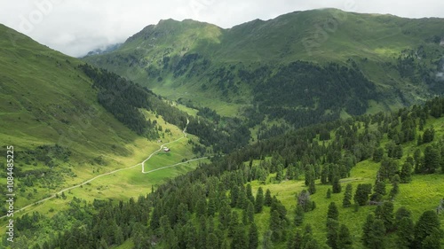 Aerial video of a valley in Austrian Alps, buildings and nature