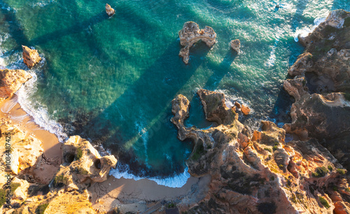 High angle view of rock formation at Camilo beach in Algarve, Portugal during sunrise