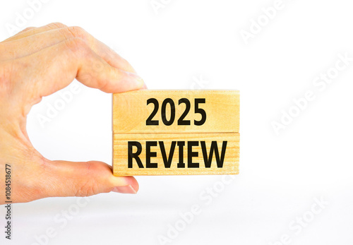 Planning 2025 review new year symbol. Concept words 2025 Review on beautiful wooden blocks. Beautiful white background. Businessman hand. Business 2025 review new year concept. Copy space.