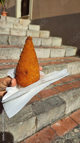 Sicilian arancini, breaded and fried in oil rice balls with meat, spinach, mushroom or tomato filling photo