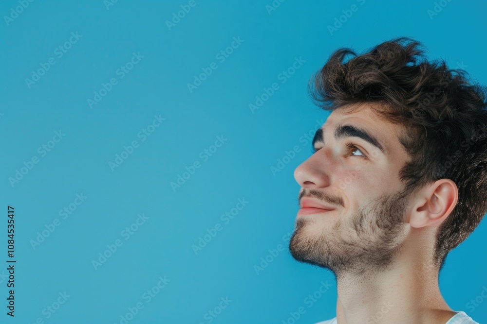 Obraz premium Young man with positive smile isolated on blue background.