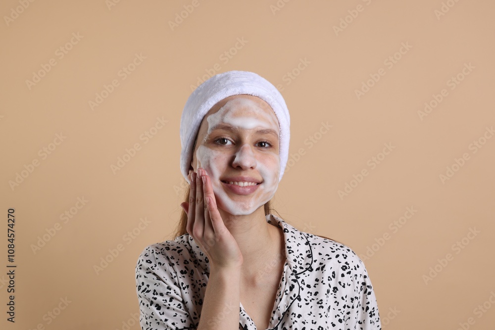 Teenage girl washing her face with cleanser on beige background. Cosmetic product Teenage girl washing her face with cleanser on beige background. Cosmetic product
