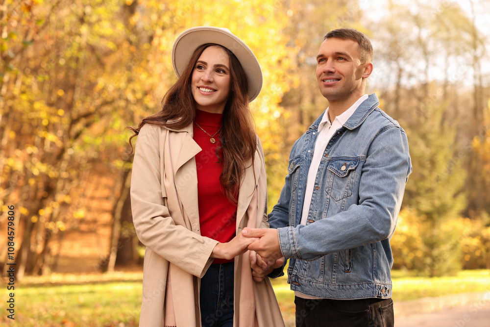 Happy couple spending time together in autumn park Happy couple spending time together in autumn park