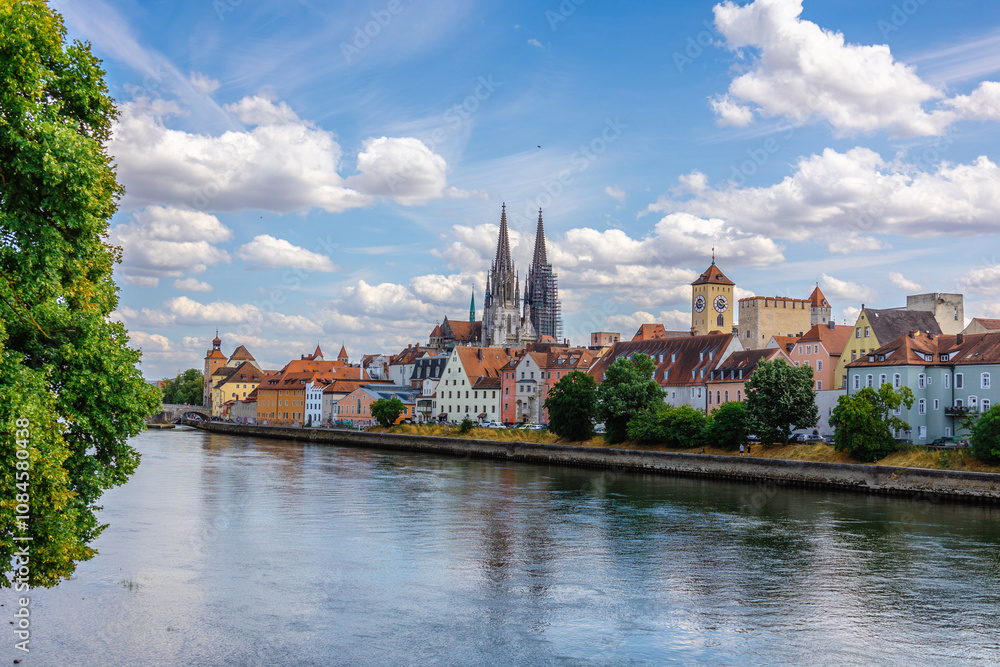Panoramic view on beautiful Stone Bridge, Cathedral and Old Town. River Danube with colorful reflection, Regensburg, Bavaria, Germany Panoramic view on beautiful Stone Bridge, Cathedral and Old Town. River Danube with colorful reflection, Regensburg, Bavaria, Germany