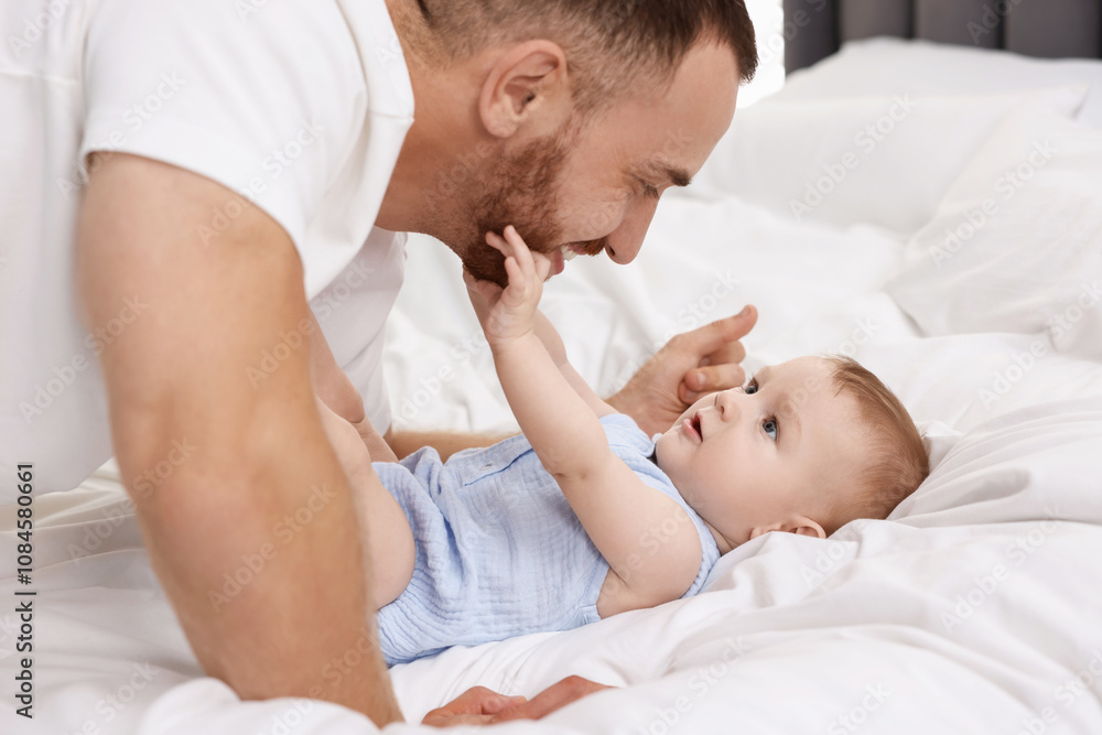 Father with his cute baby on bed at home Father with his cute baby on bed at home