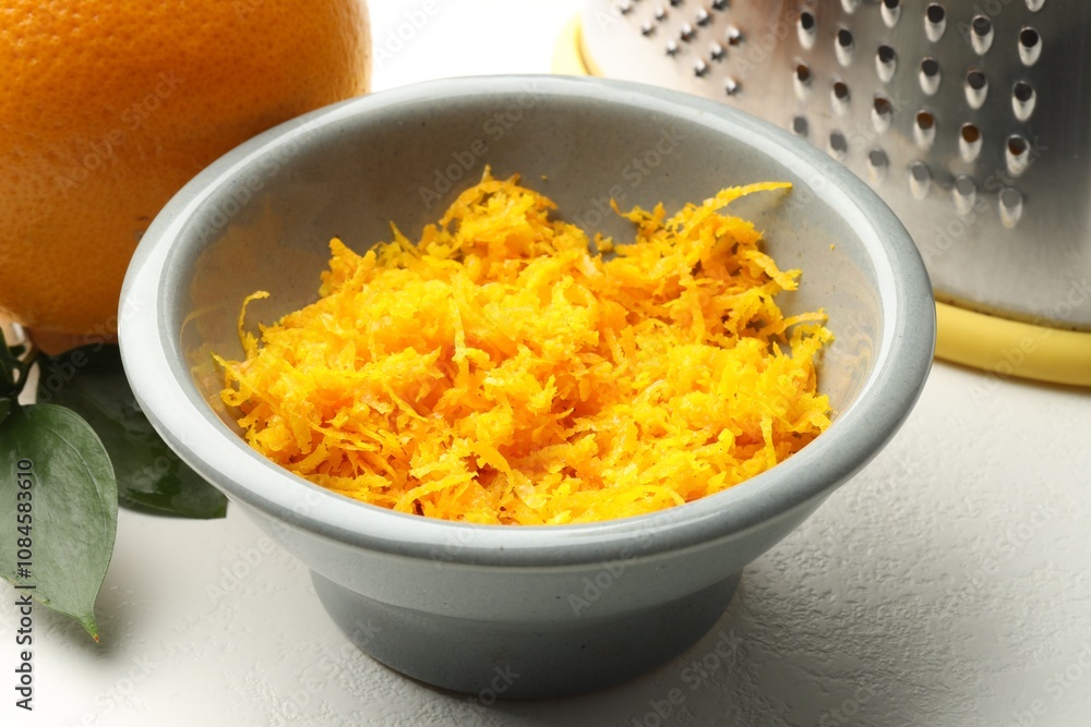 Fresh orange zest in bowl on light table, closeup Fresh orange zest in bowl on light table, closeup
